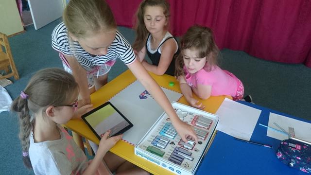 Uczennice  podczas zajęć w świetlicy szkolnej. Dziewczęta korzystają z aplikacji Scottie Go na tablecie. 